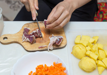 minced meat in the kitchen with a knife on a cutting board