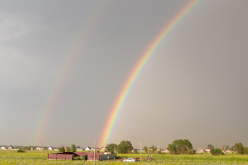 beautiful rainbow after the rain over the field