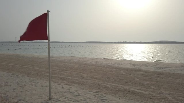 RED FLAG ON SEA SHORE - BEACH BANK - DANGER