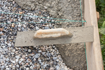 Trowel on fresh concrete at construction site