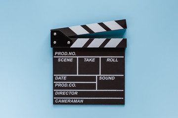 Fototapeta na wymiar Movie clapper board on blue background for filming equipment