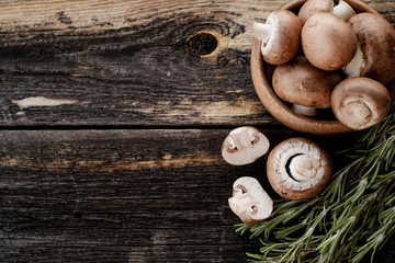  Brown mushrooms on old dark wooden background