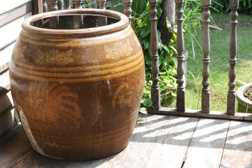 Naklejka premium Thailand traditional water jars used for drinking water on the wooden floor outdoor