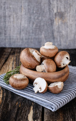  Brown mushrooms on old dark wooden background