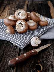  Brown mushrooms on old dark wooden background