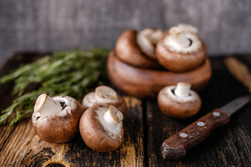  Brown mushrooms on old dark wooden background