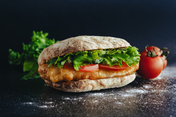 fried fish Sandwich with lettuce, tomato with tartar sauce. author's recipe street food