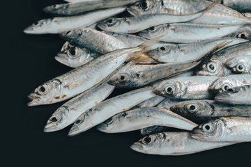 Fresh organic fish on ice on the market on dark vintage background  close-up.