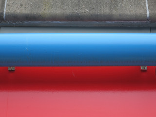 edge of a viaduct painted red wit a blue balustrade