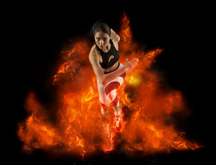 Woman running on fire background