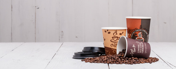 coffee bean with paper cup on wood background