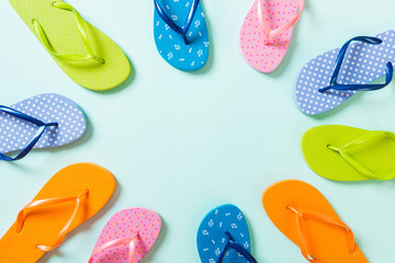 a lot of flip flop colored sandals, summer vacation on colored background, copy space top view