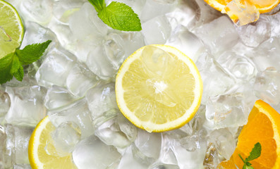Summer background with lemon slice and oranges on ice cubes