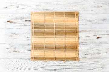 Empty Asian Food Background. brown Bamboo mat on wnite wooden background top view with copy space flat lay