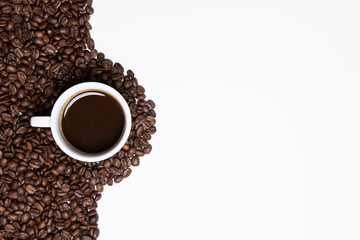 cup of coffee and beans on white background