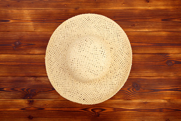 Fototapeta na wymiar Pretty beautiful straw hat on wooden background beach hat - Image