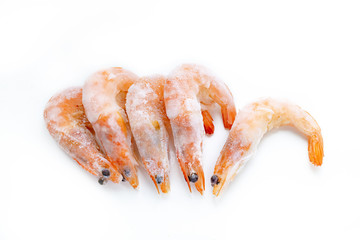 frozen shrimp lying in a row on a white background close-up