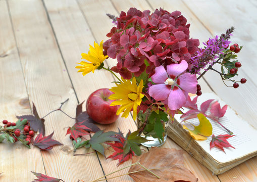 bouquet of flowers with beautiful autumnal colors on a table in leaves