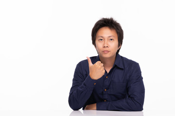 Asian Handsome man wearing casual blue shirt sitting on table showing thumbs up with confident and happiness emotional,Isolated on white background,Asian man Concept