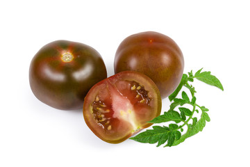 Whole and half tomatoes kumato on a white background