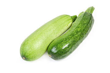 Green zucchini and vegetable marrow on a white background