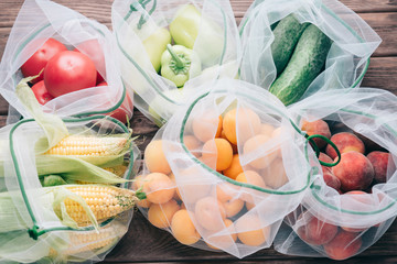 Fruits and vegetables in reusable eco mesh bags.