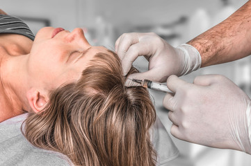 Woman with hair problem is receiving injection
