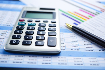 Calculator on charts and graphs spreadsheet paper. Finance, Account, Statistics, Analytic research data and Business company meeting concept