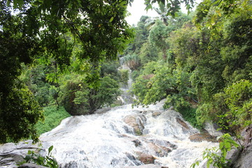 Fototapeta na wymiar waterfall in green landscape