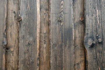 Background from old wood texture. Softwood boards. Annual rings and cuts from branches (knots) Beautiful, natural pattern. Summer, sunny day.