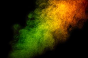 Bright green and yellow smoke isolated on black background is macro