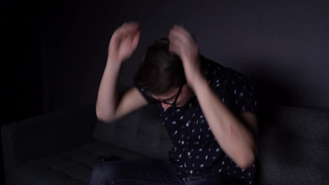 Caucasian Man Try Harding Game on Phone in Apartment Living Room and Losing