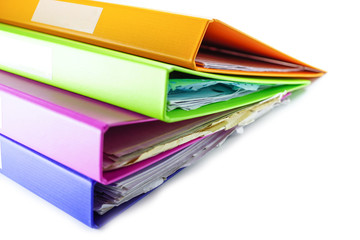 File Folder Binder stack of multi color on table in office.