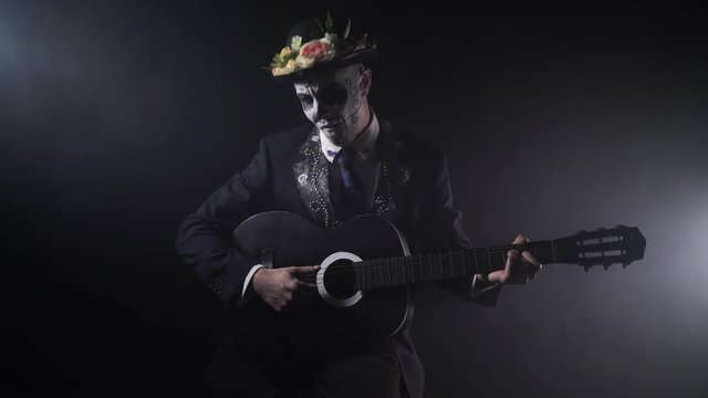 Mariachi with the Santa Muerte face paint is playing the guitar, 4k