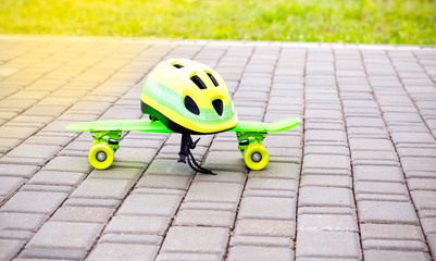 Kids safety. Green helmet and green  skateboard