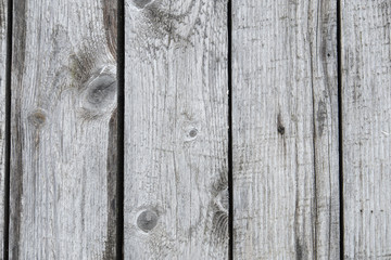 Background from old wood texture. Softwood boards. Annual rings and cuts from branches (knots) Beautiful, natural pattern. Summer, sunny day.