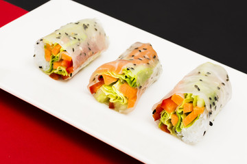 Close-up of tasty steamed rice spring rolls on white place