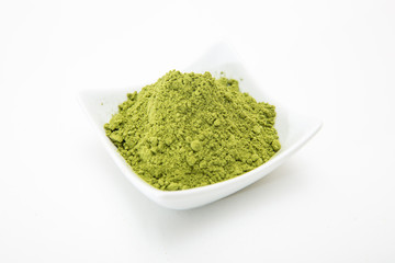 Healthy organic barley grass green powder isolated on white background. Barley grass powder for...