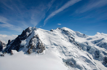 Fototapeta na wymiar Air view. Beautiful dramatic cloudy sky , mountains and snow peaks. Mont Blanc. Chamonix. France