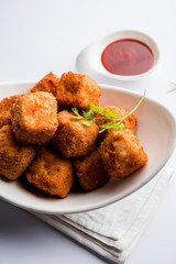 Crispy Paneer popcorn is a popular party snack and an appetiser. selective focus