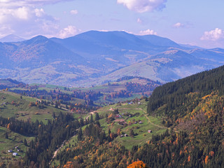 Fototapeta premium Carpatian village at mountains at the sunny day