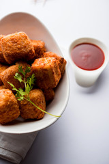 Crispy Paneer popcorn is a popular party snack and an appetiser. selective focus