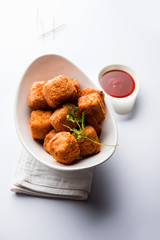 Crispy Paneer popcorn is a popular party snack and an appetiser. selective focus