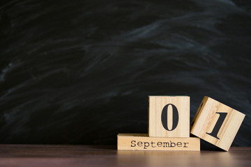 School background. Date of 1 september set on wooden calendar with blackboard background. copyspace