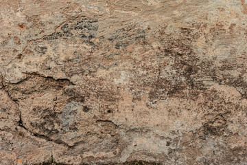 Texture of a concrete wall with cracks and scratches which can be used as a background