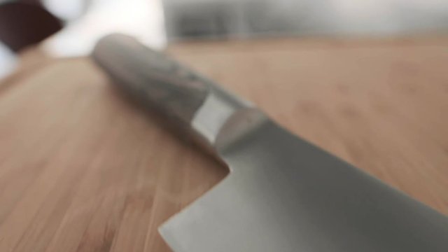 Steel bright and sharp knife on wood surface.