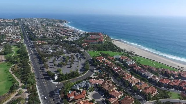 Aerial drone flyover of luxury homes in Laguna Niguel towards Ritz Carlton Hotel, Orange County, California