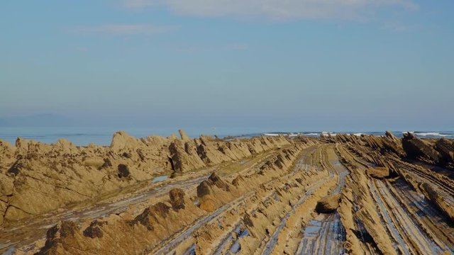 Crane down shot of geological formations at coast