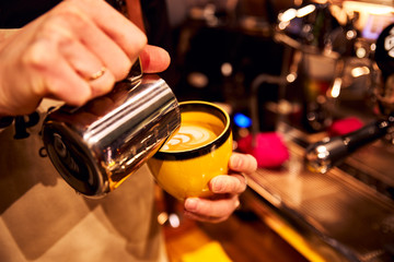 Cappuccino latte with pattern. Large contrast shot of coffee. Concept of cooking and love coffee beans and drinks. Soft colors warm tones
