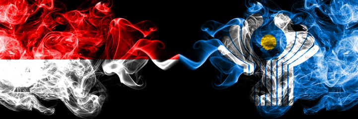 Indonesia vs Commonwealth smoky mystic flags placed side by side. Thick colored silky smoke flags of Indonesia and Commonwealth